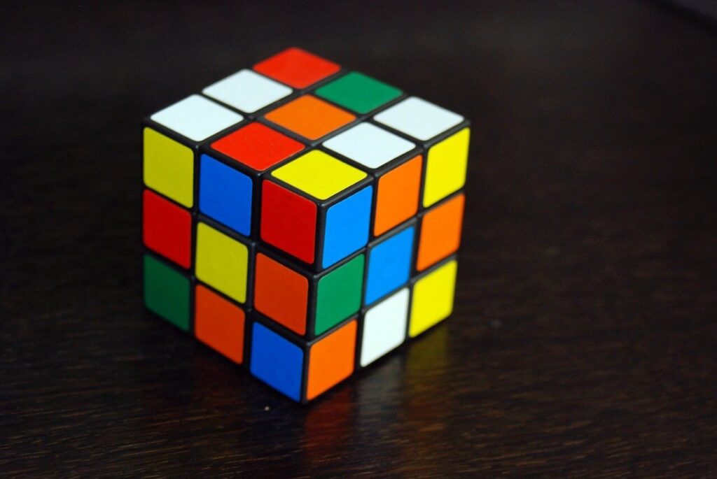 Scrambled Rubik's Cube on a dark wooden tabletop